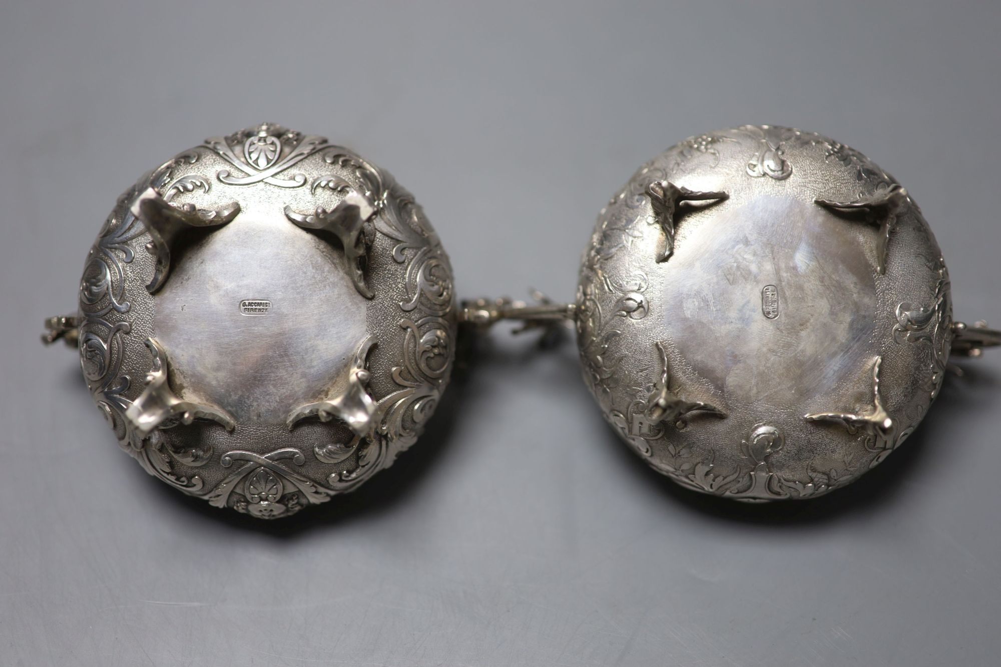 A pair of Italian white metal two handled sweetmeat bowls, by G Accarisi, with figural handles, dia. 85mm, 8oz.